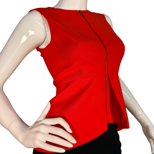 Red sleeveless top on a mannequin with a white background