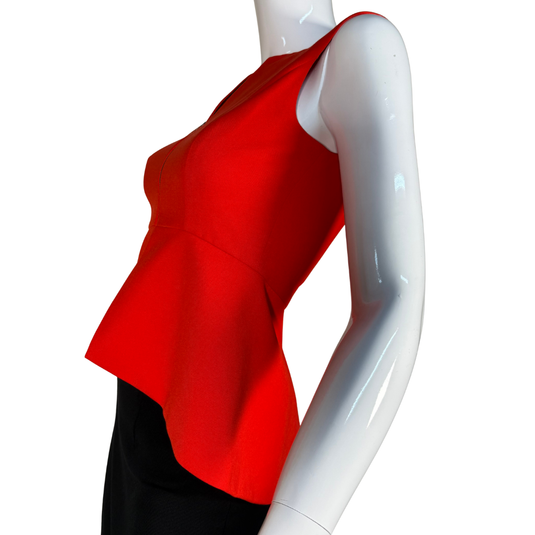 Red sleeveless top on a mannequin against a white background