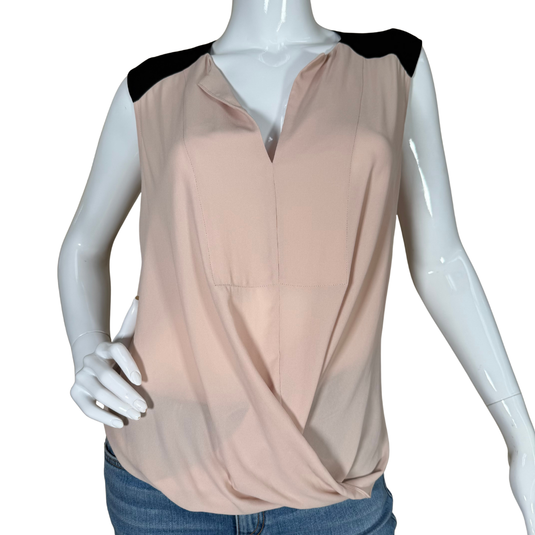 Mannequin wearing a beige sleeveless top with black shoulders on a white background