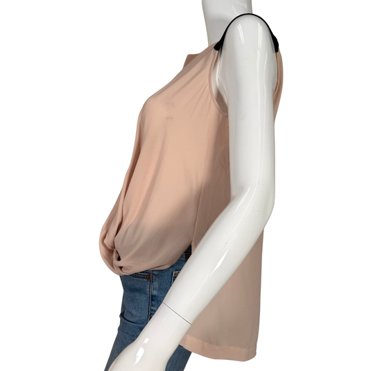 Mannequin wearing a beige sleeveless top and blue jeans on a white background