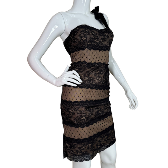 Black lace dress on a white mannequin against a white background