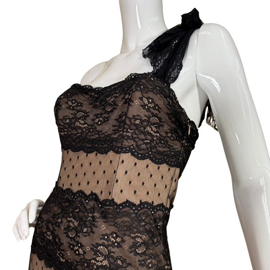 Black lace dress on a mannequin against a white background