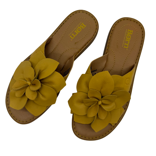 Børn Yellow Leather Flower Slide Sandals. Handcrafted with a bold, oversized leather flower accent and cushioned footbed