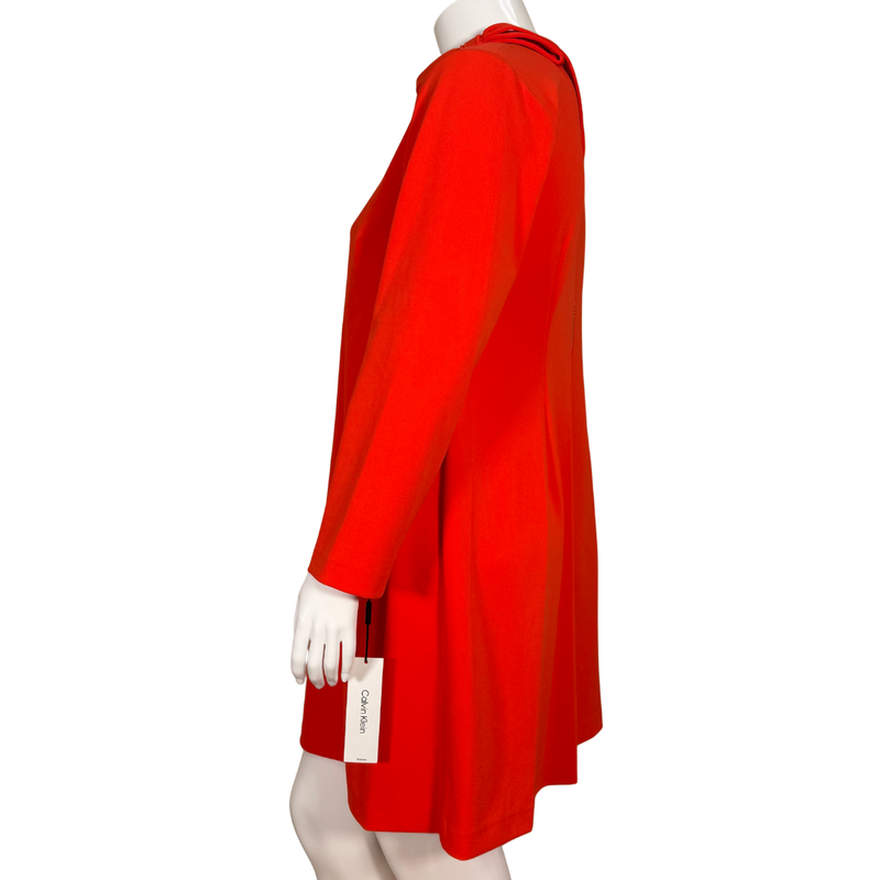 Load image into Gallery viewer, elegant donated Calvin Klein Red Long-Sleeve Shift Dress with Bow Detail features a high neckline accented with a charming bow tie on the shoulder, adding a touch of sophistication
