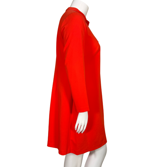 Red dress on a white mannequin against a white background