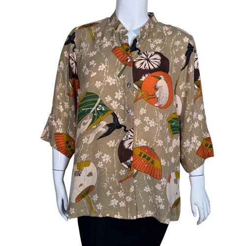 Mannequin wearing a patterned shirt with colorful designs on a white background