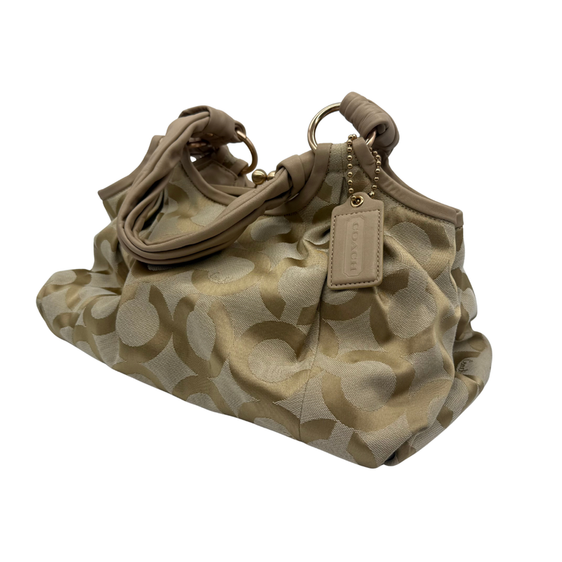 Load image into Gallery viewer, Beige handbag with a pattern and visible brand tag on a white background
