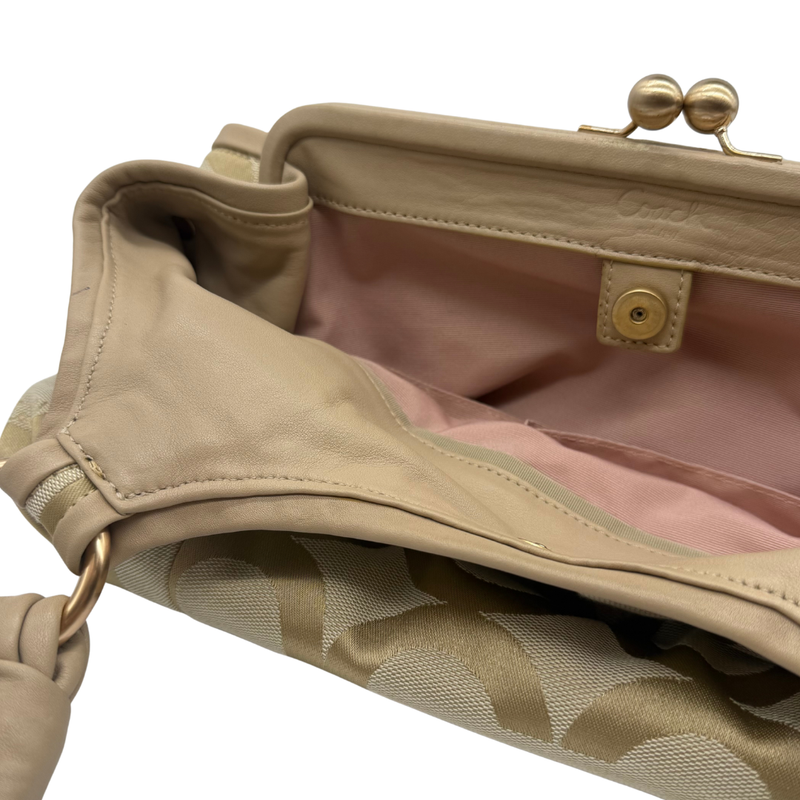 Load image into Gallery viewer, Close-up of a beige handbag with a gold clasp on a white background
