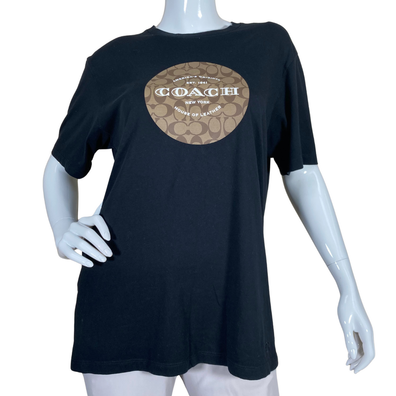 Load image into Gallery viewer, Coach Black Tee with Monogram is a black short-sleeve T-shirt featuring a Coach logo design on the front - front view
