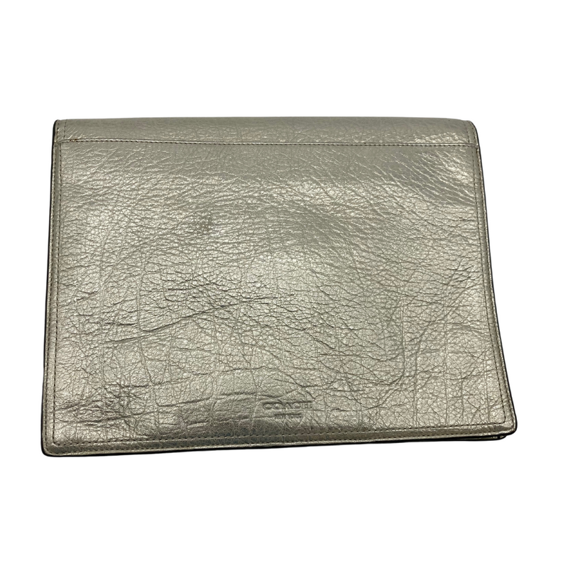 Load image into Gallery viewer, This pre-loved Coach Champagne Gold Clutch item is a metallic silver clutch bag with a textured finish resembling crinkled leather. It features a flap closure secured by a twist-lock mechanism, giving it a sleek and elegant look.
