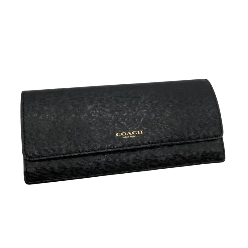 Load image into Gallery viewer, This pre-loved Coach Mini Black Purse with Gold Zipper with a sleek and minimalist design. It features the iconic “COACH New York” logo in gold lettering on the front. The wallet is made of textured leather and has a flap closure. Its compact size makes it perfect for carrying essentials like cards, cash, and small items.&nbsp;
