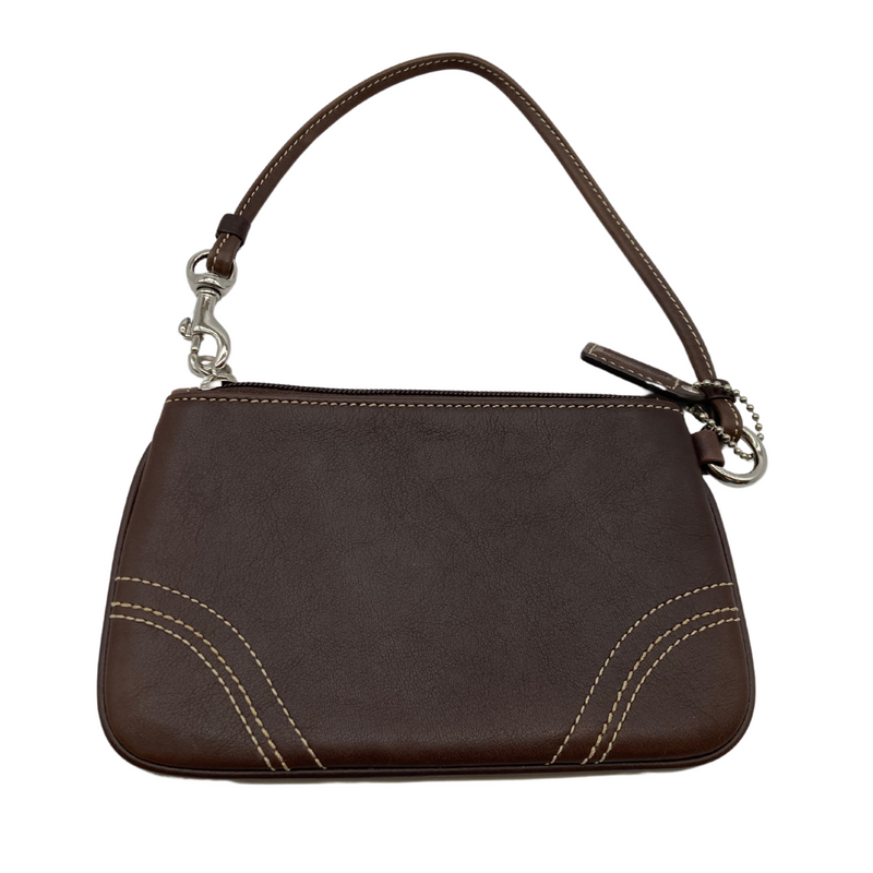 Load image into Gallery viewer, This pre-loved Coach Mini Brown Wristlet Pouch item is a compact wristlet pouch in a rich brown tone with contrast white stitching. It features a zippered closure and a detachable wrist strap for convenient carrying.
