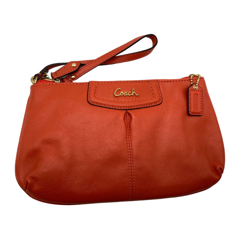 Load image into Gallery viewer, Coach Small Slim Orange Hand Purse in a orange red leather. It features a sleek and minimalistic design with a wrist strap for easy carrying.
