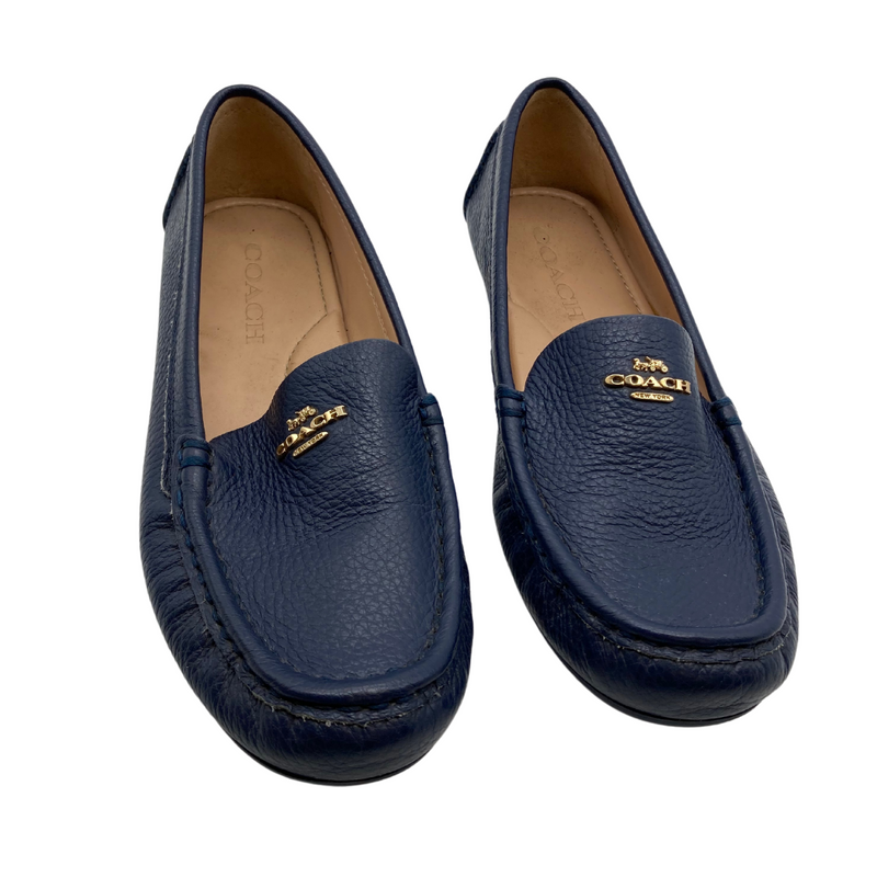 Load image into Gallery viewer, Coach Blue Leather Flats are sleek black leather loafers by Coach, featuring a pebbled texture and a slip-on design for comfort and convenience.
