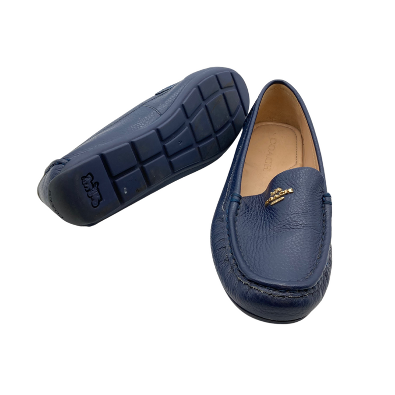 Load image into Gallery viewer, Coach Blue Leather Flats are sleek black leather loafers by Coach, featuring a pebbled texture and a slip-on design for comfort and convenience.
