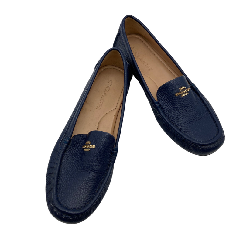 Load image into Gallery viewer, Coach Blue Leather Flats are sleek black leather loafers by Coach, featuring a pebbled texture and a slip-on design for comfort and convenience.
