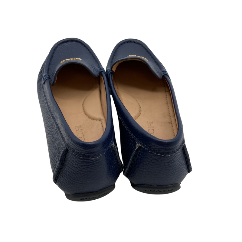 Load image into Gallery viewer, Coach Blue Leather Flats are sleek black leather loafers by Coach, featuring a pebbled texture and a slip-on design for comfort and convenience.
