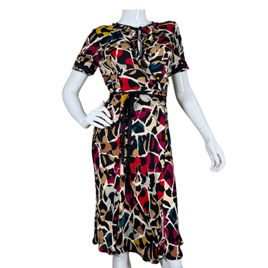 pre-loved eye-catching Diane von Furstenberg Silk Wrap Dress adorned with a playful abstract print in hues of red, mustard, cream, black, and blue