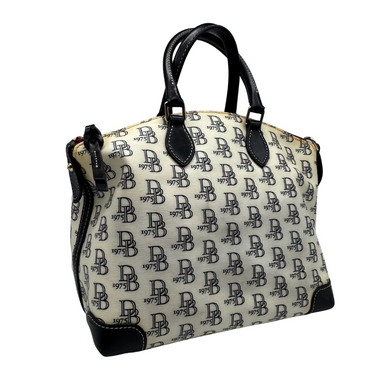 Classic and stylish thrifted Dooney & Bourke White Handbag with Monogram Pattern showcases a neutral cream-colored canvas covered in a repeating black “DB” logo pattern