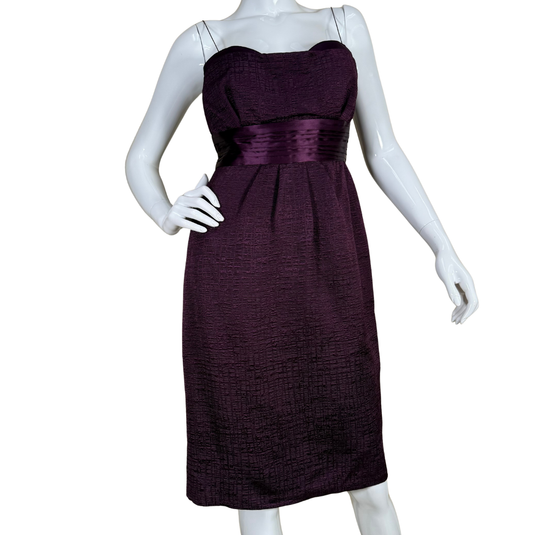 Purple strapless dress on a mannequin against a white background