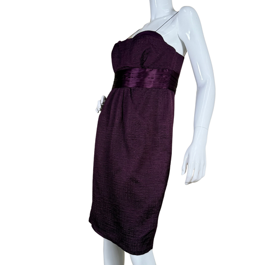 Purple dress on a mannequin against a white background