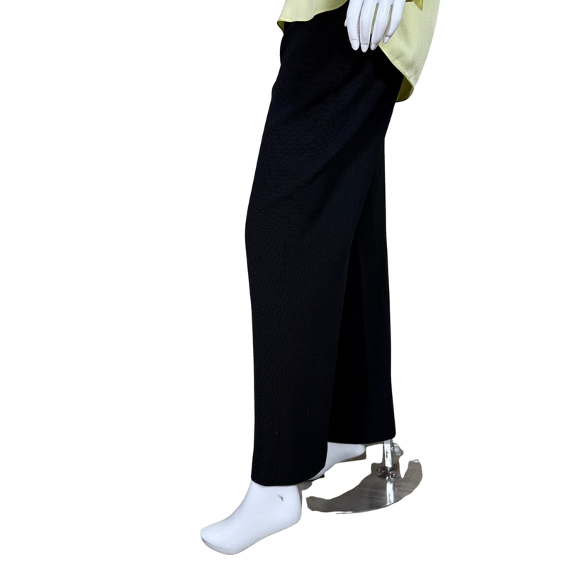 Load image into Gallery viewer, Black wide-leg pants worn by a person on a white background
