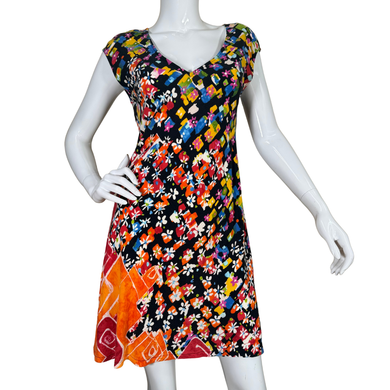 Colorful floral dress on a mannequin against a white background