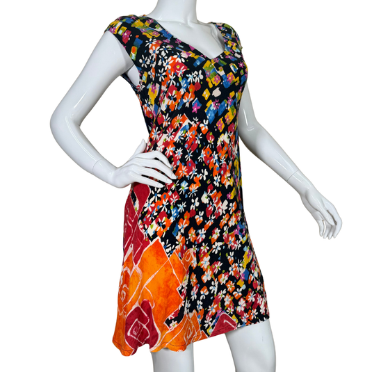 Colorful floral dress on a mannequin against a white background