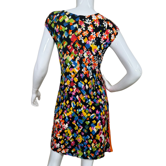 Mannequin wearing a colorful floral dress on a white background