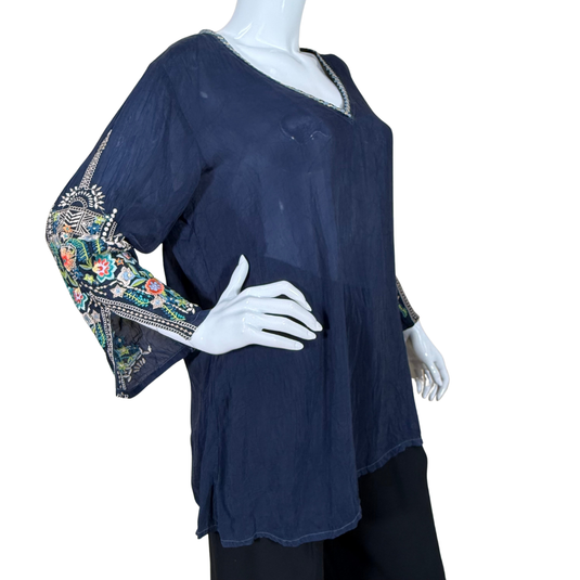 Navy blue blouse with floral embroidery on sleeves on a mannequin against a white background