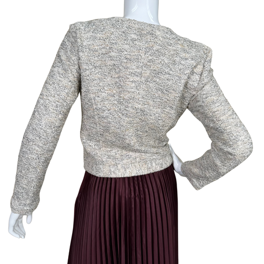 Mannequin wearing a textured gray sweater and pleated maroon skirt on a white background
