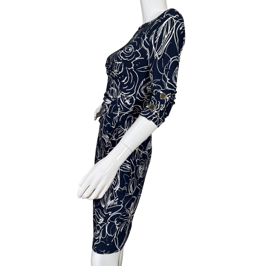Navy blue dress with white floral pattern on a mannequin against a white background