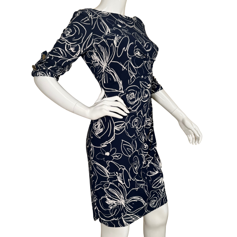 Load image into Gallery viewer, Navy dress with white floral pattern on a mannequin against a white background
