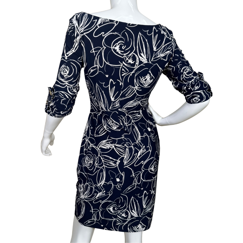 Load image into Gallery viewer, Navy blue dress with white floral pattern on a mannequin against a white background
