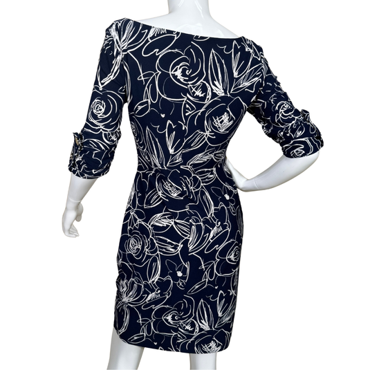 Navy blue dress with white floral pattern on a mannequin against a white background