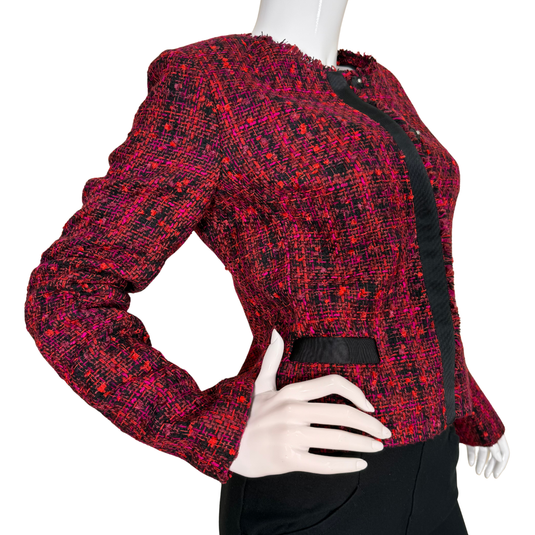 Red and black patterned jacket on a mannequin against a white background