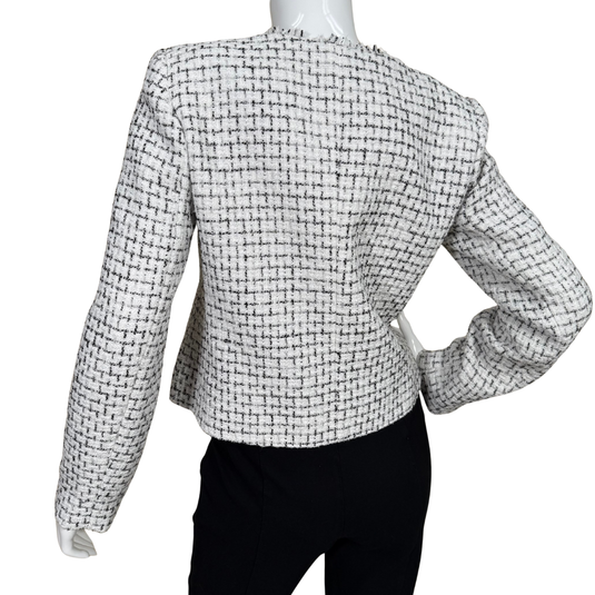 Black and white checkered jacket on a mannequin against a white background