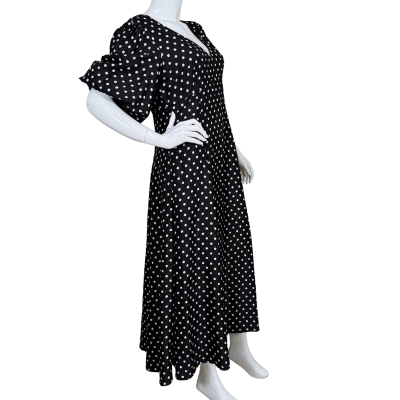 Load image into Gallery viewer, Black polka dot dress on a mannequin against a white background
