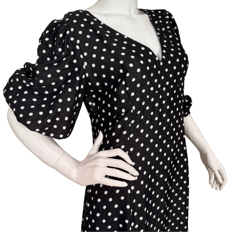 Load image into Gallery viewer, Black dress with white polka dots on a mannequin against a white background
