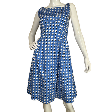 charming sleeveless Kate Spade Blue Dress With Abstract White and Black Squares features a classic fit-and-flare silhouette with a flattering cinched waist and pleated skirt
