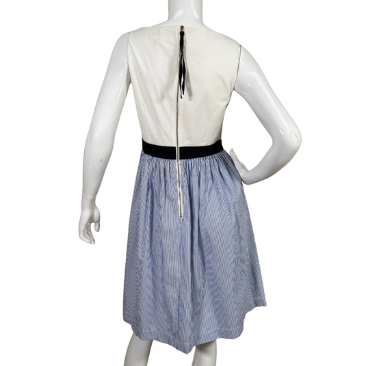 Mannequin wearing a white top and blue striped skirt on a white background