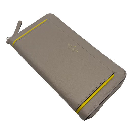Kate Spade Elegant Beige Clutch Purse with Yellow Accent in a chic beige leather accented by playful pops of vibrant yellow.