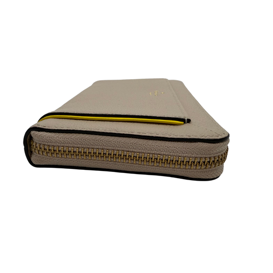 Beige zippered case with a yellow interior lining on a white background
