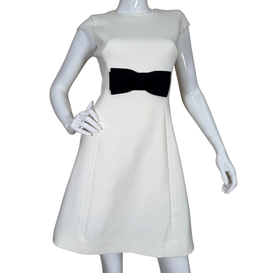 Timeless elegance meets playful detail in this donated Kate Spade Sophisticated White Dress with Black Bow featuring a classic crew neckline and a striking black bow at the waist