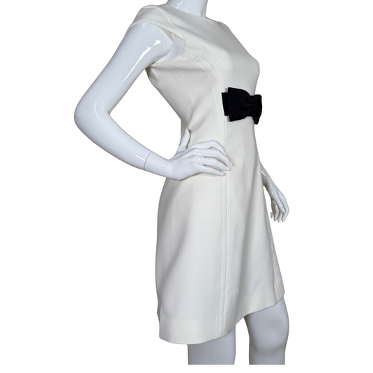 Timeless elegance meets playful detail in this donated Kate Spade Sophisticated White Dress with Black Bow featuring a classic crew neckline and a striking black bow at the waist