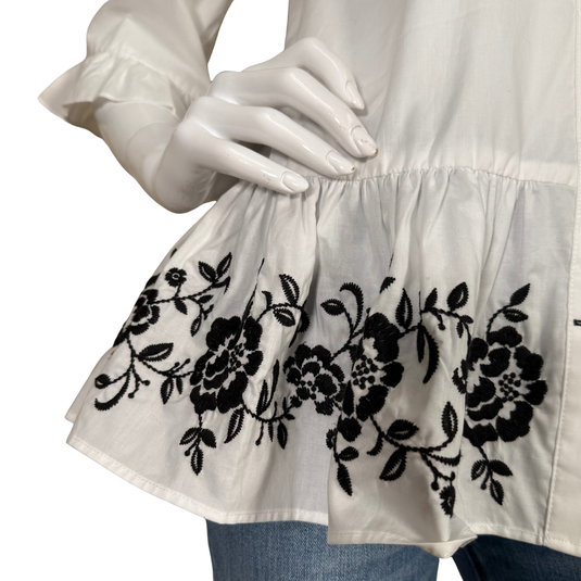 Kate Spade White Peplum Blouse with Embroidered Hem features a classic collared button-up design with a feminine twist