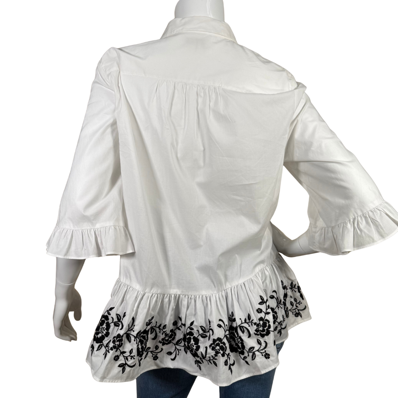 Load image into Gallery viewer, White blouse with ruffled sleeves and black embroidery on a white background
