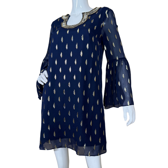Navy blue dress with gold patterns on a mannequin against a white background