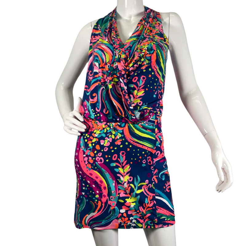 Load image into Gallery viewer,  Lilly Pultizer Psychedelic Neck Drop Cinched Waist Minidress is a vibrant, sleeveless dress with a colorful abstract pattern featuring shades of pink, green, yellow, and blue on a dark navy background - front view
