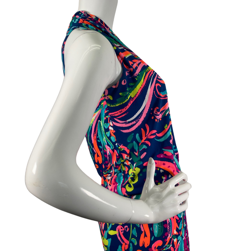 Load image into Gallery viewer,  Lilly Pultizer Psychedelic Neck Drop Cinched Waist Minidress is a vibrant, sleeveless dress with a colorful abstract pattern featuring shades of pink, green, yellow, and blue on a dark navy background - side view close-up
